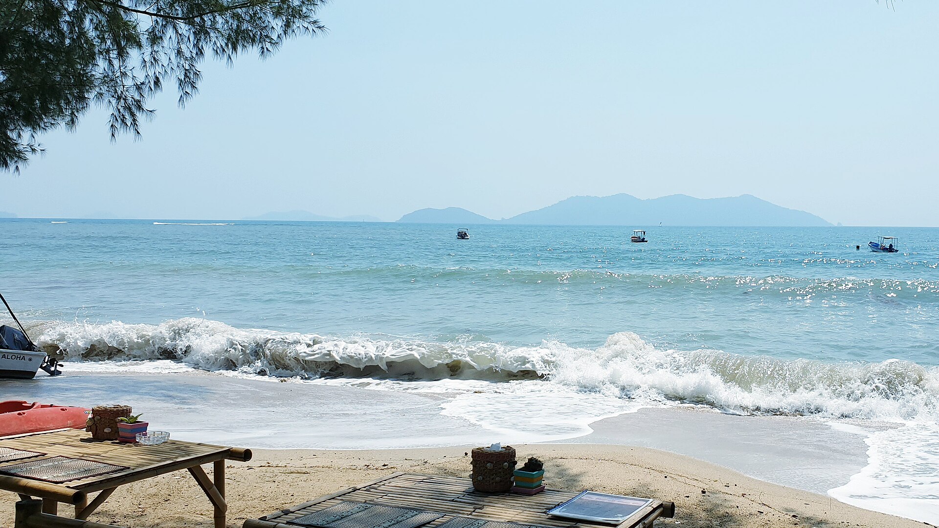 Forested hills meeting a quiet beach on Koh Chang